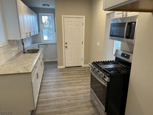a kitchen with stainless steel appliances granite countertop a stove and a sink