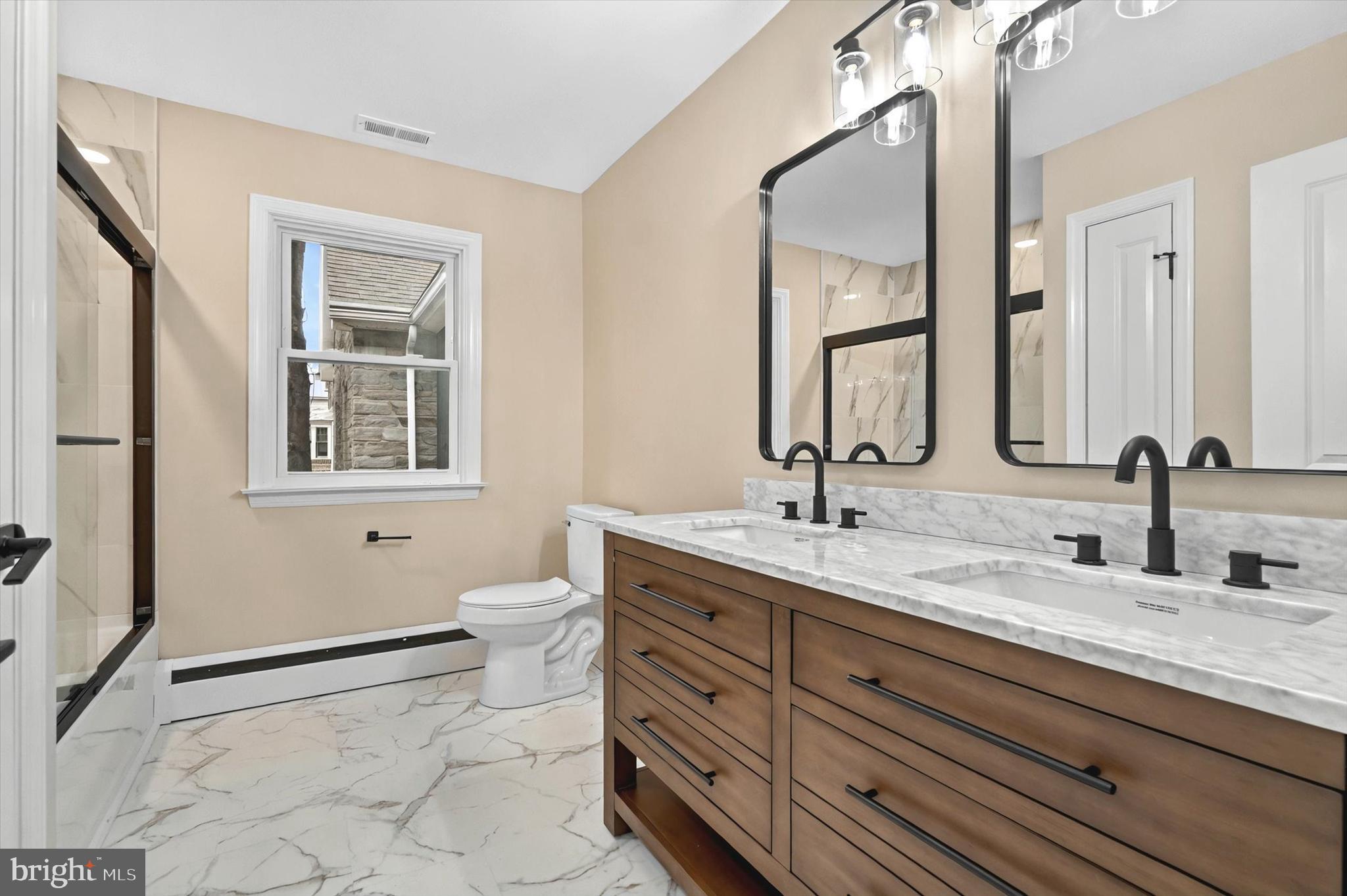 1853 Eastern Boulevard York, PA 17402 - Photo 14 of 38 a bathroom with a granite countertop toilet sink and mirror