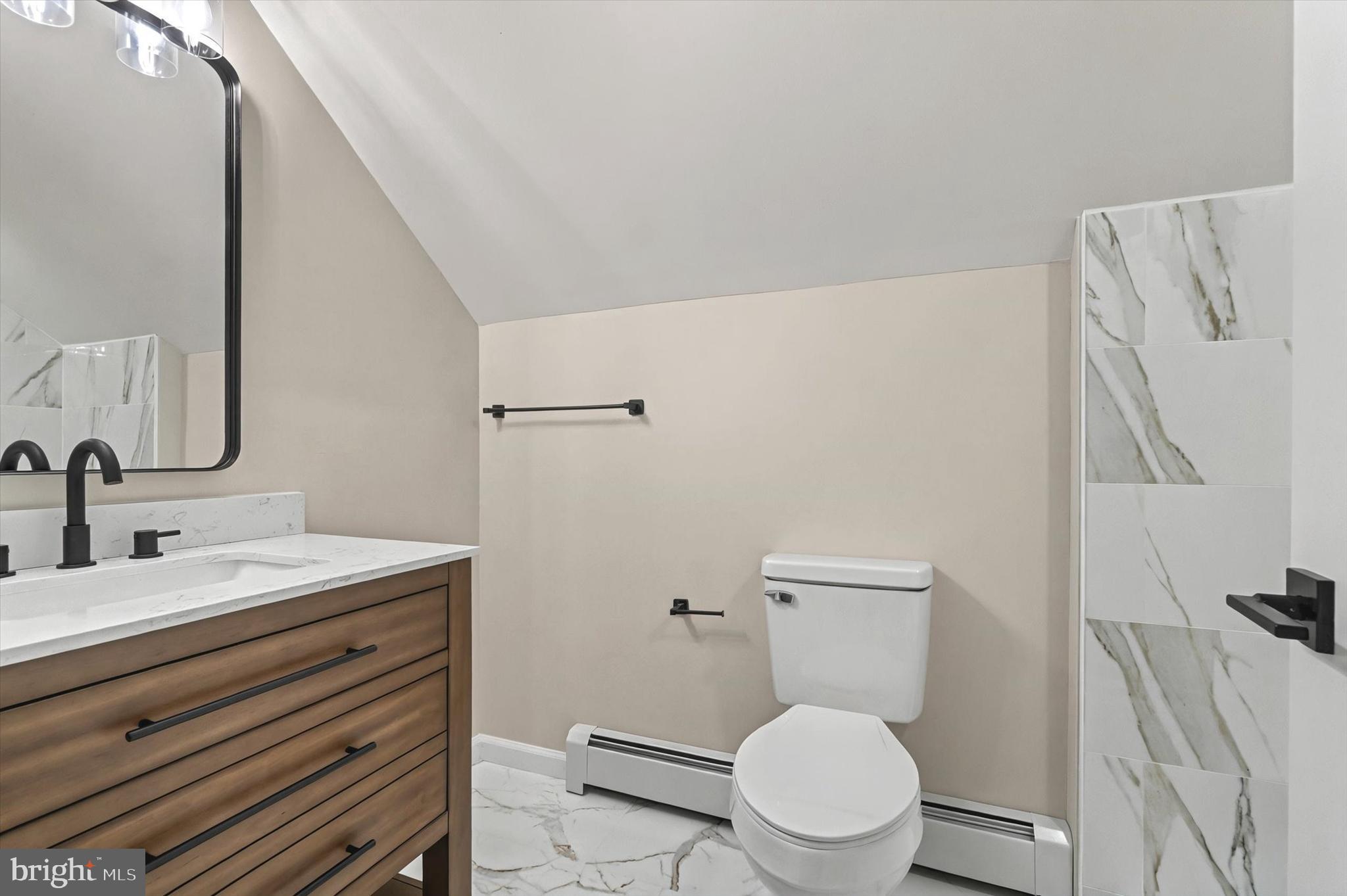 1853 Eastern Boulevard York, PA 17402 - Photo 26 of 38 a bathroom with a toilet a sink and a mirror