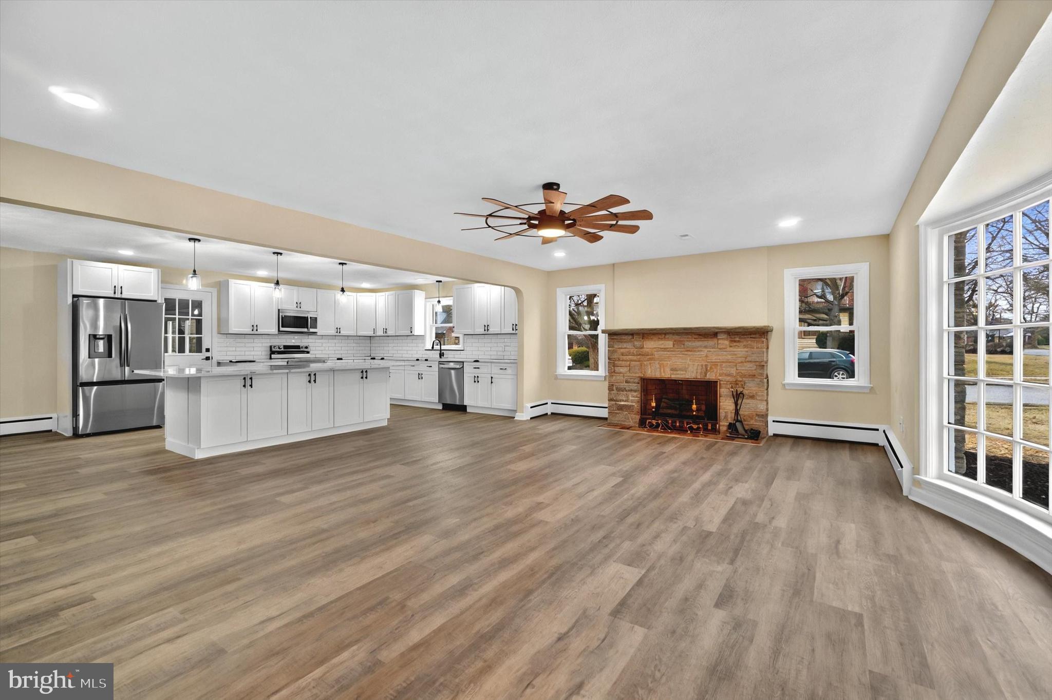 1853 Eastern Boulevard York, PA 17402 - Photo 5 of 38 a view of a living room kitchen with a flat screen tv and a fireplace