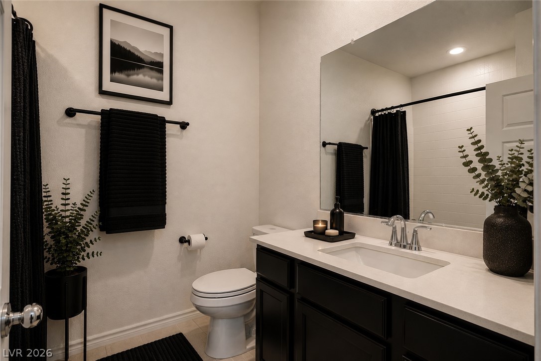 7330 North Decatur Boulevard, Unit 6 North Las Vegas, NV 89084 - Photo 12 of 42 A well-appointed bathroom features a single vanity, sleek fixtures, and a shower with a dark curtain.