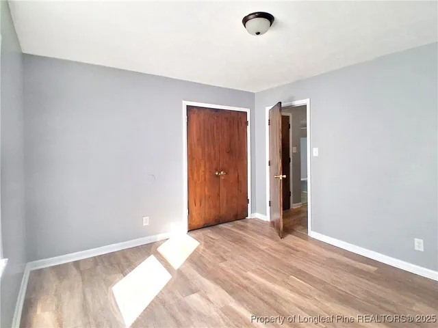 a view of a livingroom with wooden floor and a ceiling fan