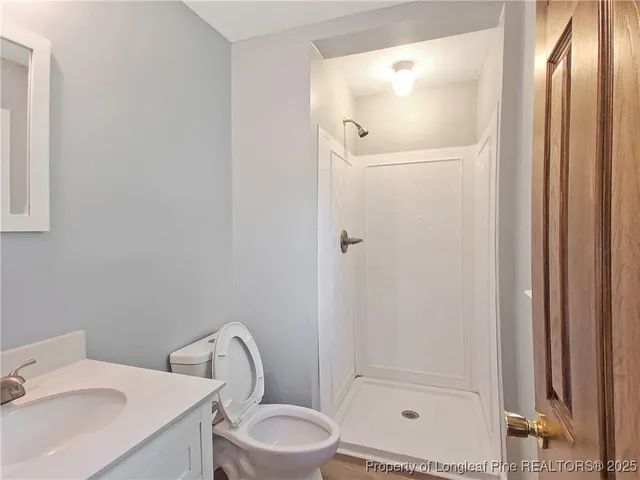 a bathroom with a toilet sink and shower