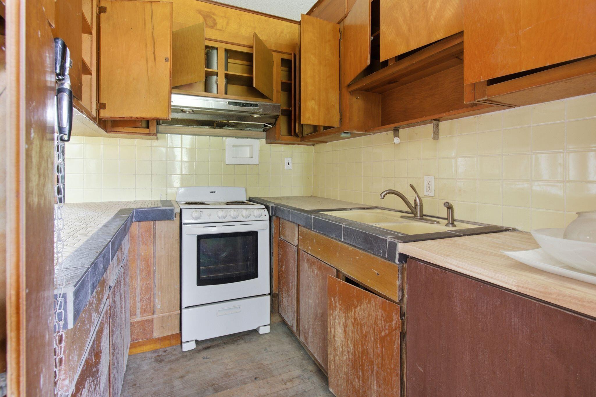 855 North Pearl Street Crestview, FL 32536 - Photo 8 of 31 a kitchen with stainless steel appliances granite countertop a sink and a stove
