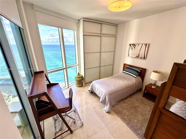 a bed room with a bed and glass door