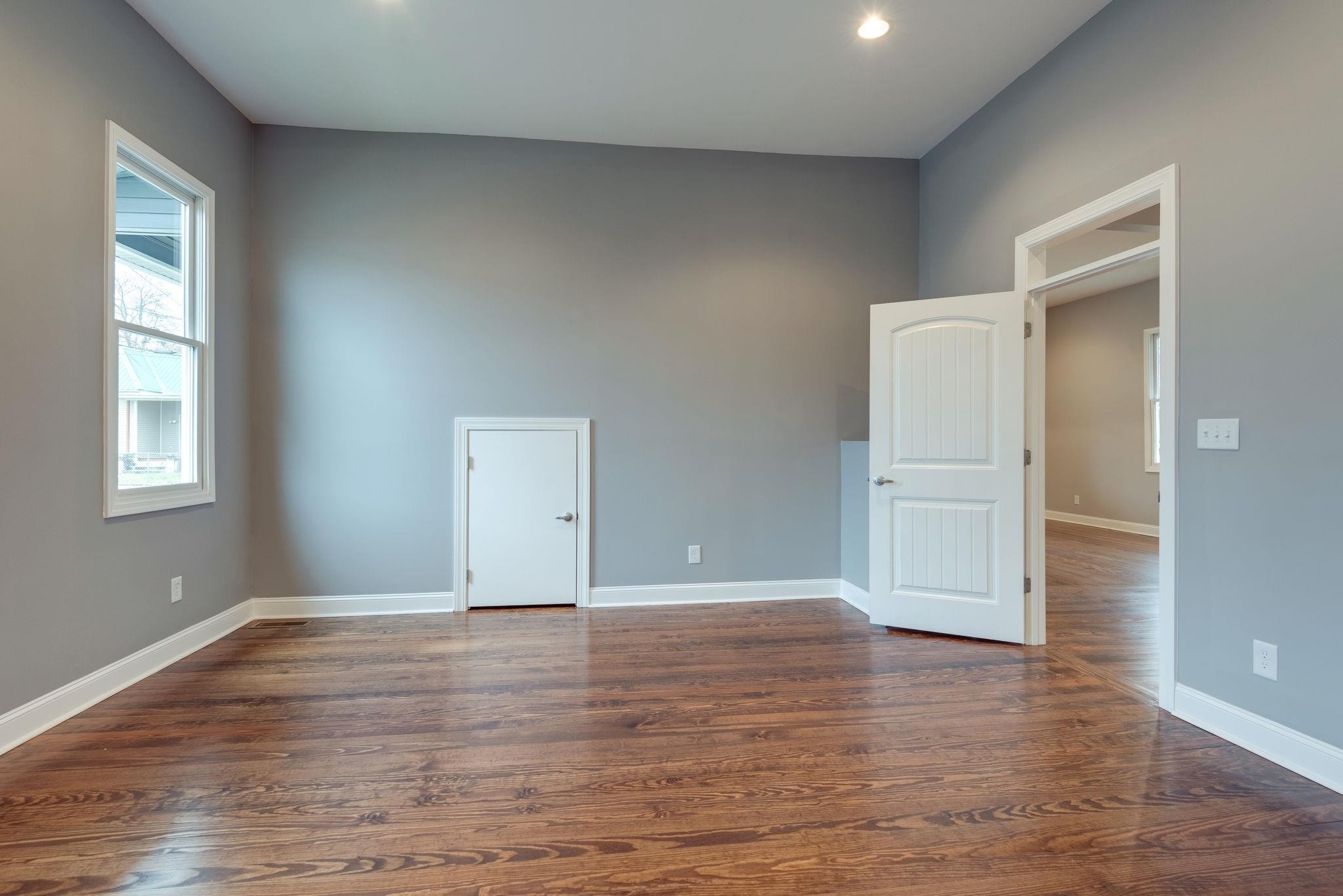 1012 Cheatham Street Springfield, TN 37172 - Photo 18 of 25 a view of an empty room with wooden floor and a window