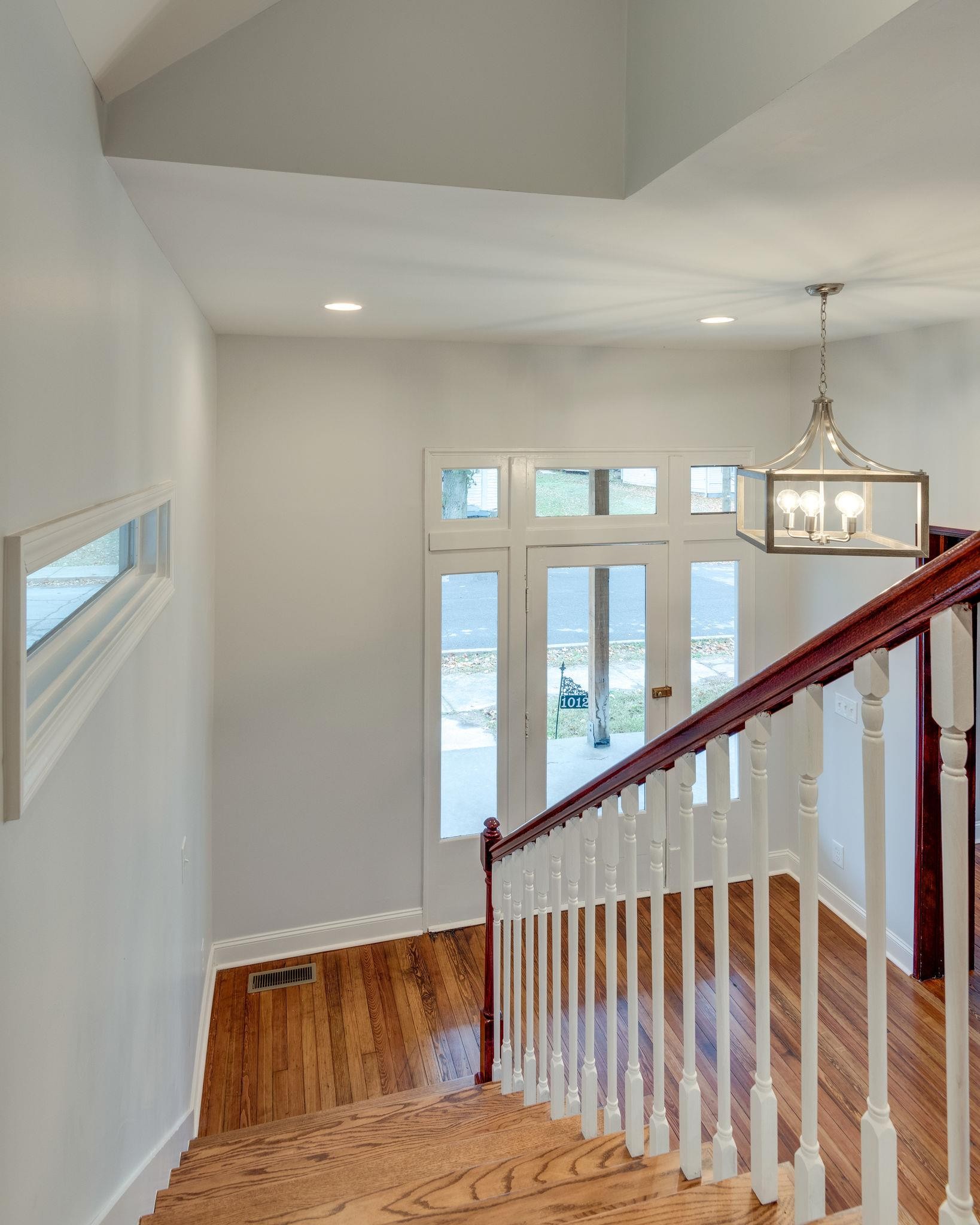 1012 Cheatham Street Springfield, TN 37172 - Photo 19 of 25 a view of staircase with lots of frames on wall and wooden floor