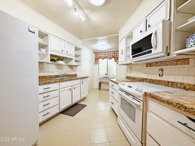 a kitchen with stainless steel appliances white cabinets and stove