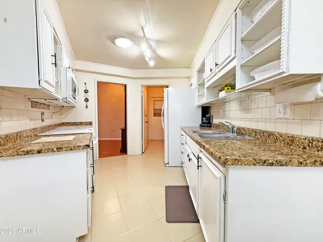 a kitchen with stainless steel appliances granite countertop a sink and a stove