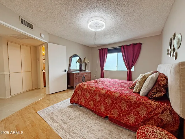 a bedroom with a large bed and a window