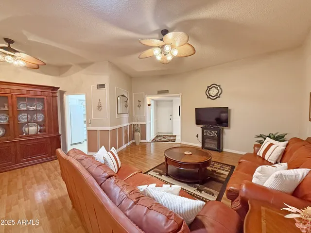 a living room with furniture a rug and a flat screen tv