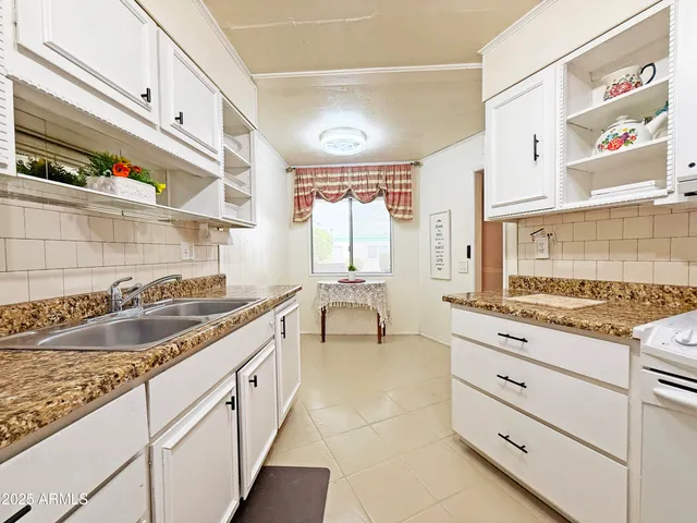 a kitchen with granite countertop a sink and a stove
