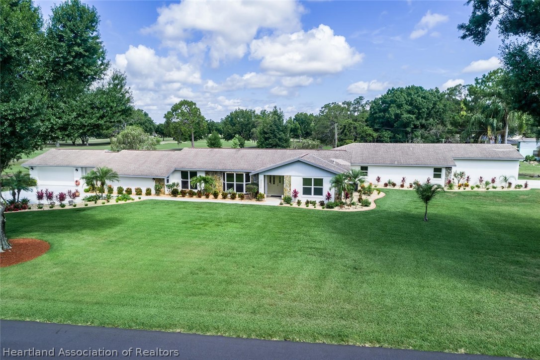 3800 Par Road Sebring, FL 33872 - Photo 1 of 24 a view of a house with a big yard
