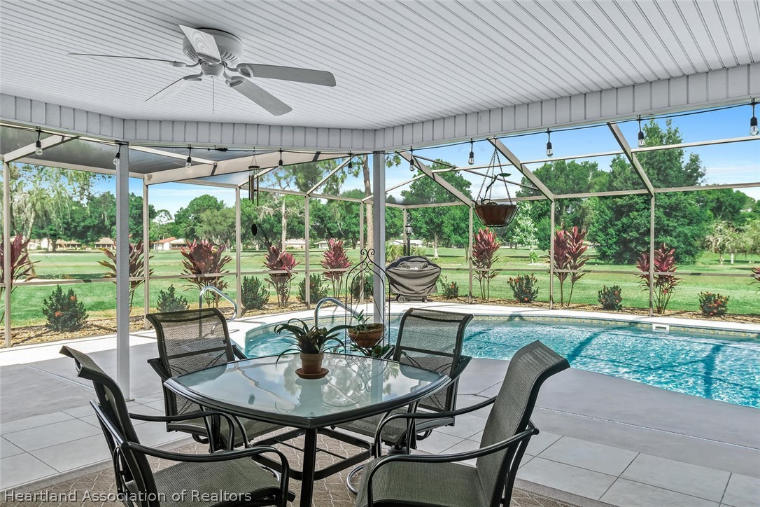 3800 Par Road Sebring, FL 33872 - Photo 11 of 24 a view of patio with table and chairs potted plants and floor to ceiling window