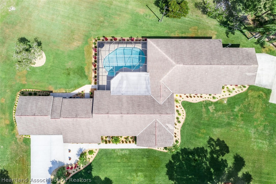 3800 Par Road Sebring, FL 33872 - Photo 2 of 24 an aerial view of a house with a garden and a yard