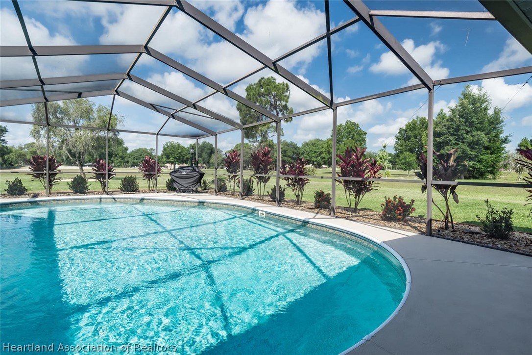 3800 Par Road Sebring, FL 33872 - Photo 23 of 24 a view of a backyard with a small deck and a garden