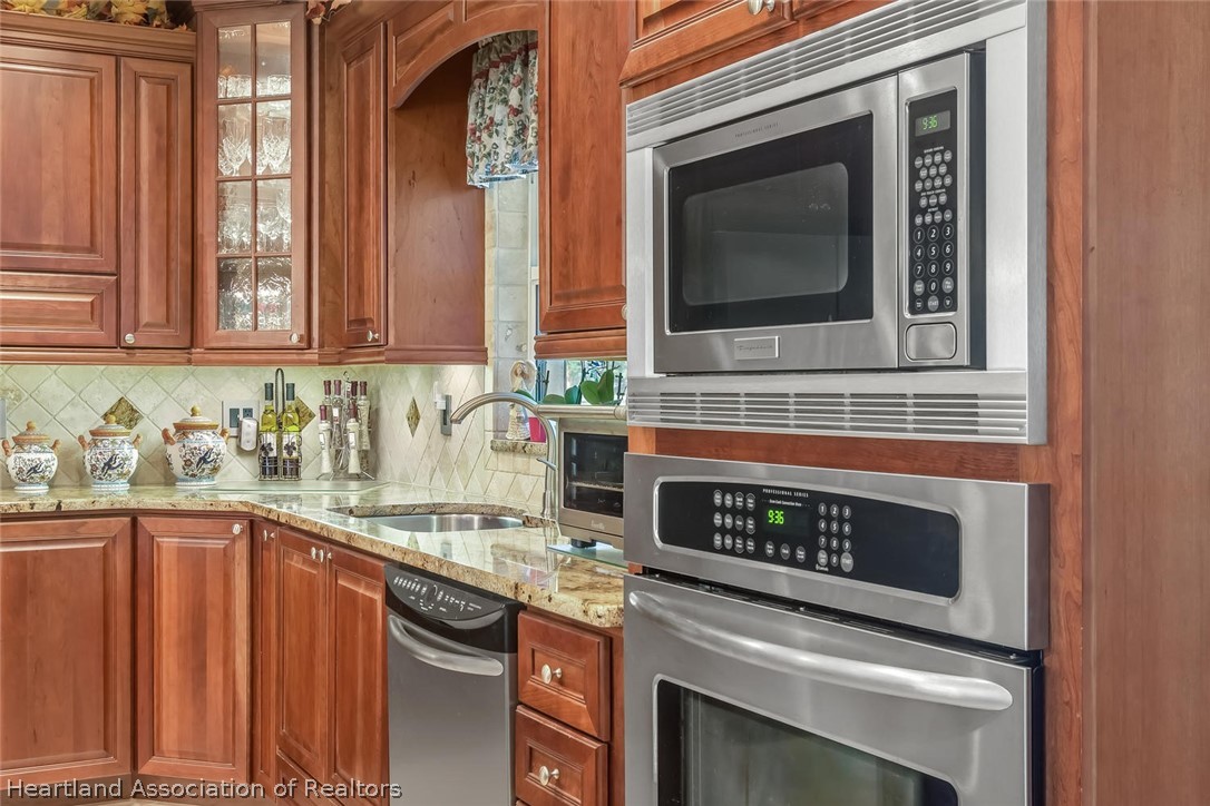 3800 Par Road Sebring, FL 33872 - Photo 9 of 24 a kitchen with granite countertop a stove top oven cabinetry a sink and dishwasher