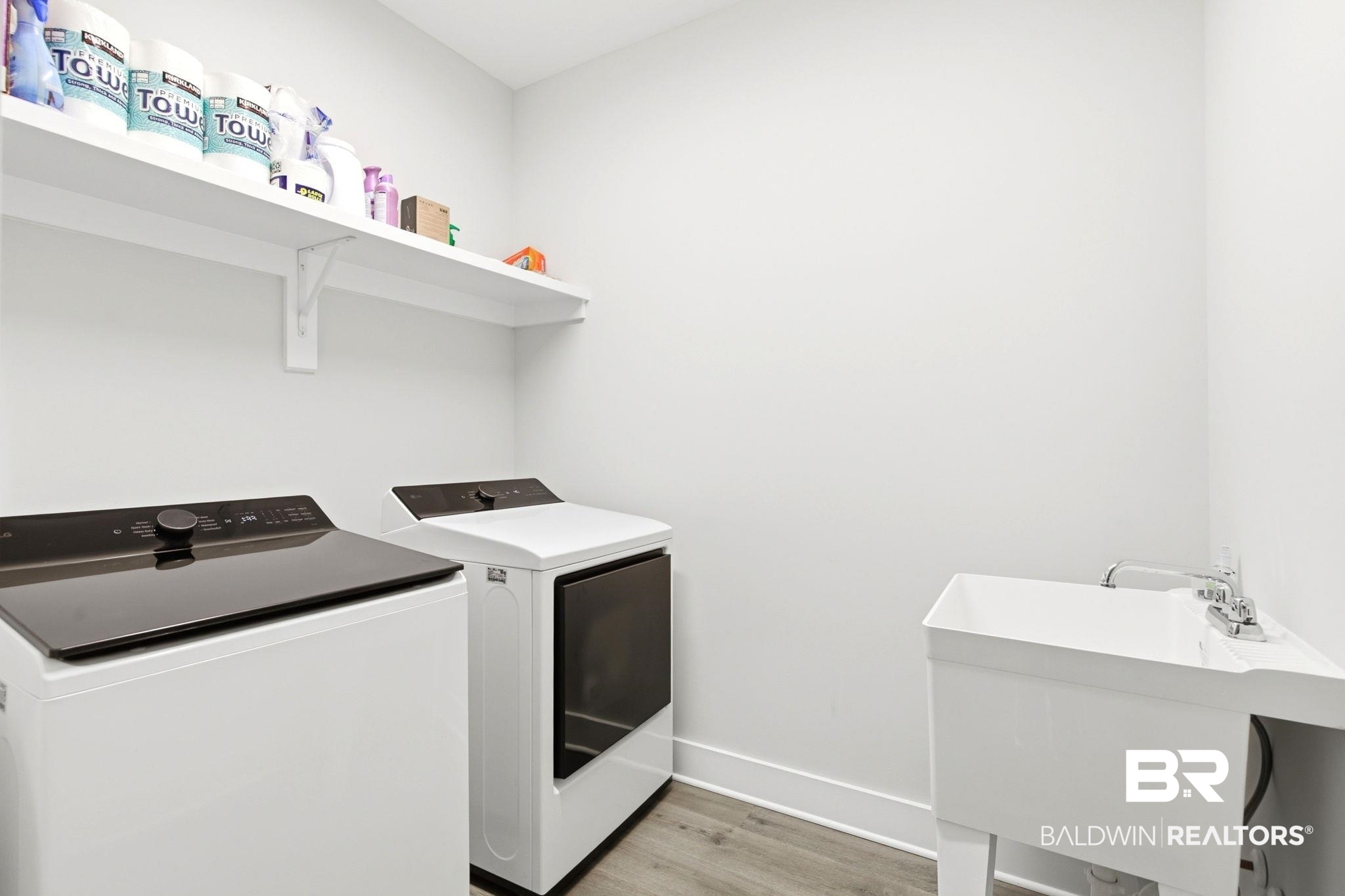 12132 Exbury Way Daphne, AL 36527 - Photo 26 of 47 Laundry area featuring light wood finished floors and washing machine and clothes dryer
