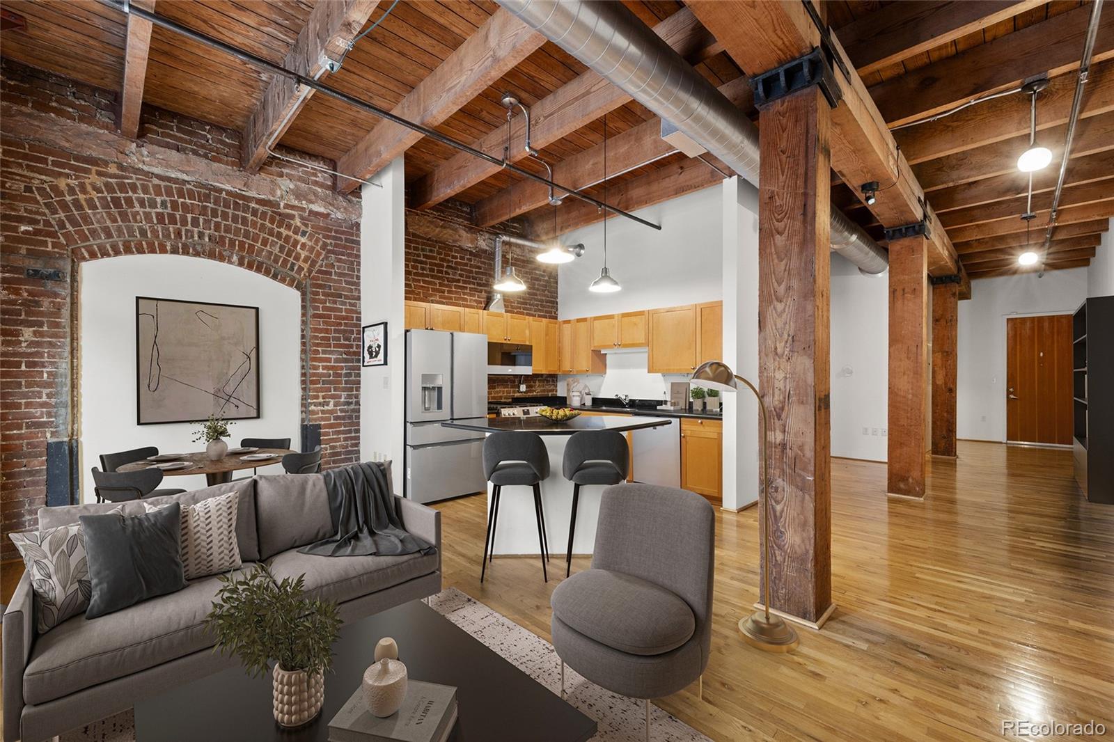 a living room with furniture and a view of kitchen