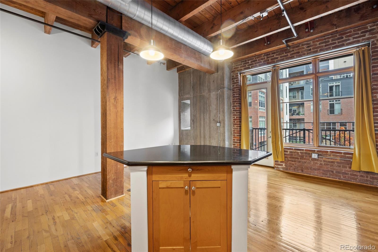 2960 Inca Street, Unit 208 Denver, CO 80202 - Photo 11 of 43 a view of a hallway with wooden floor and a window