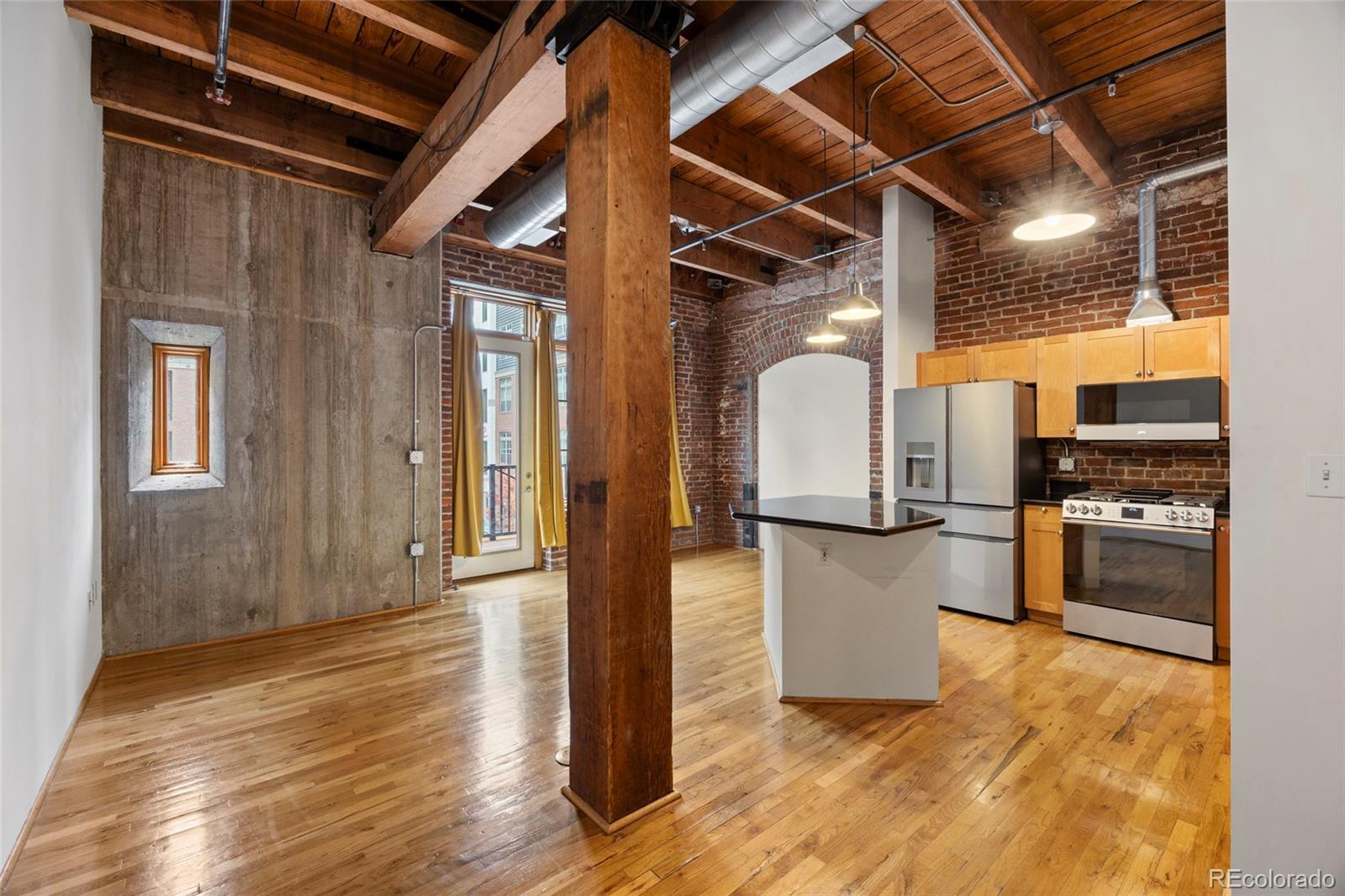 2960 Inca Street, Unit 208 Denver, CO 80202 - Photo 19 of 43 a view of a kitchen with refrigerator and wooden floor