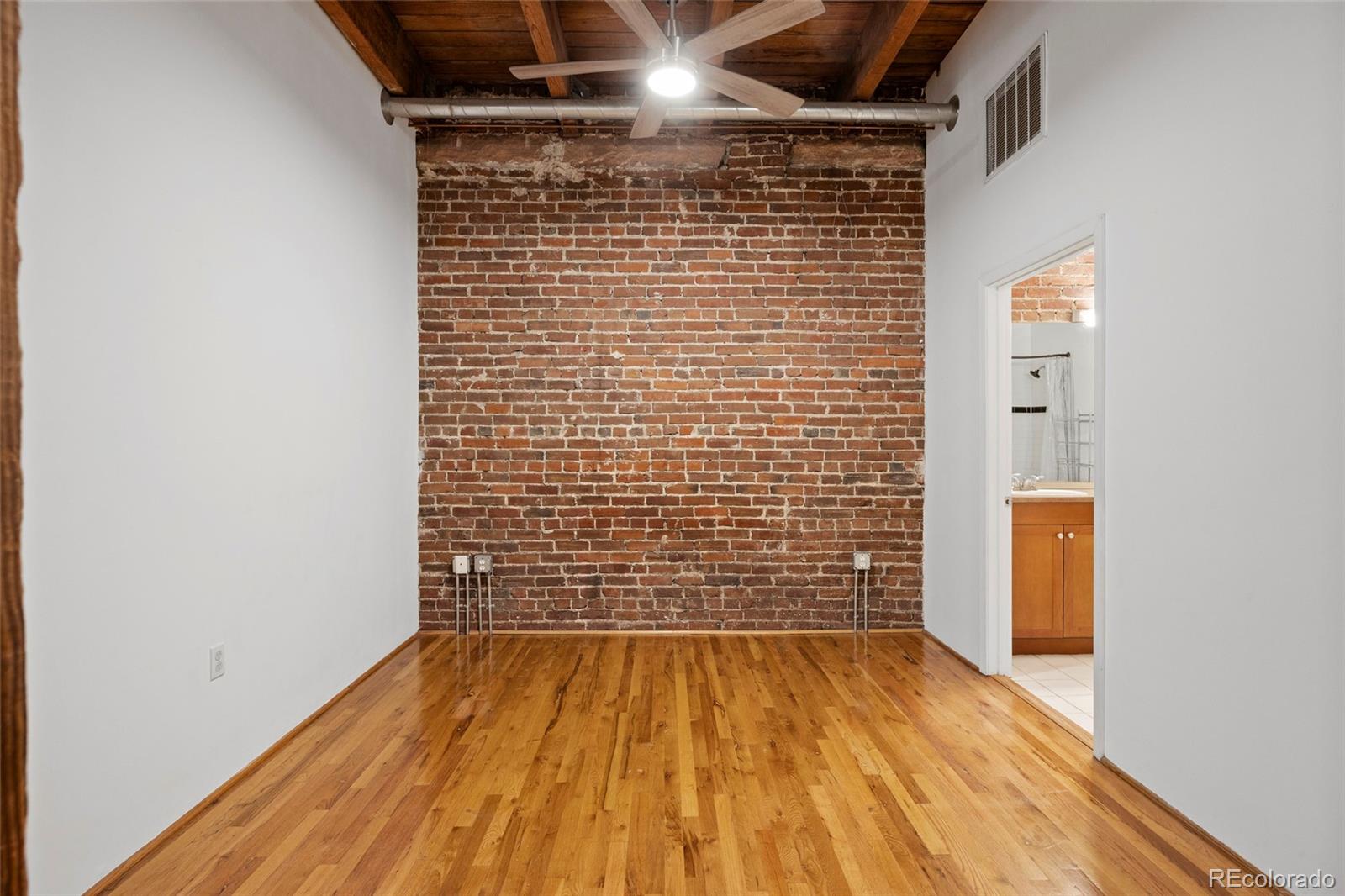 2960 Inca Street, Unit 208 Denver, CO 80202 - Photo 21 of 43 a view of empty room with wooden floor and door