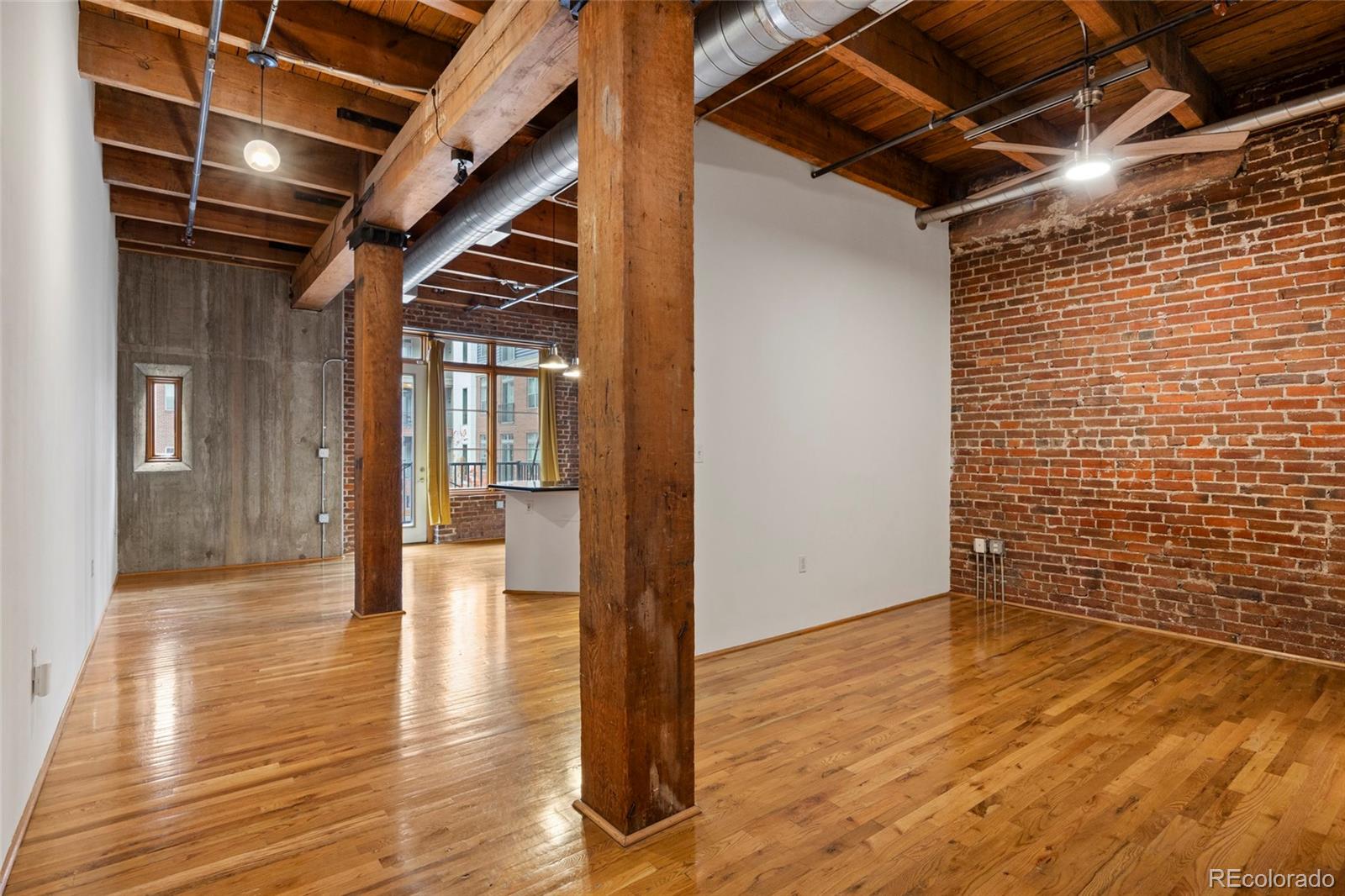 2960 Inca Street, Unit 208 Denver, CO 80202 - Photo 22 of 43 a view of an empty room with wooden floor