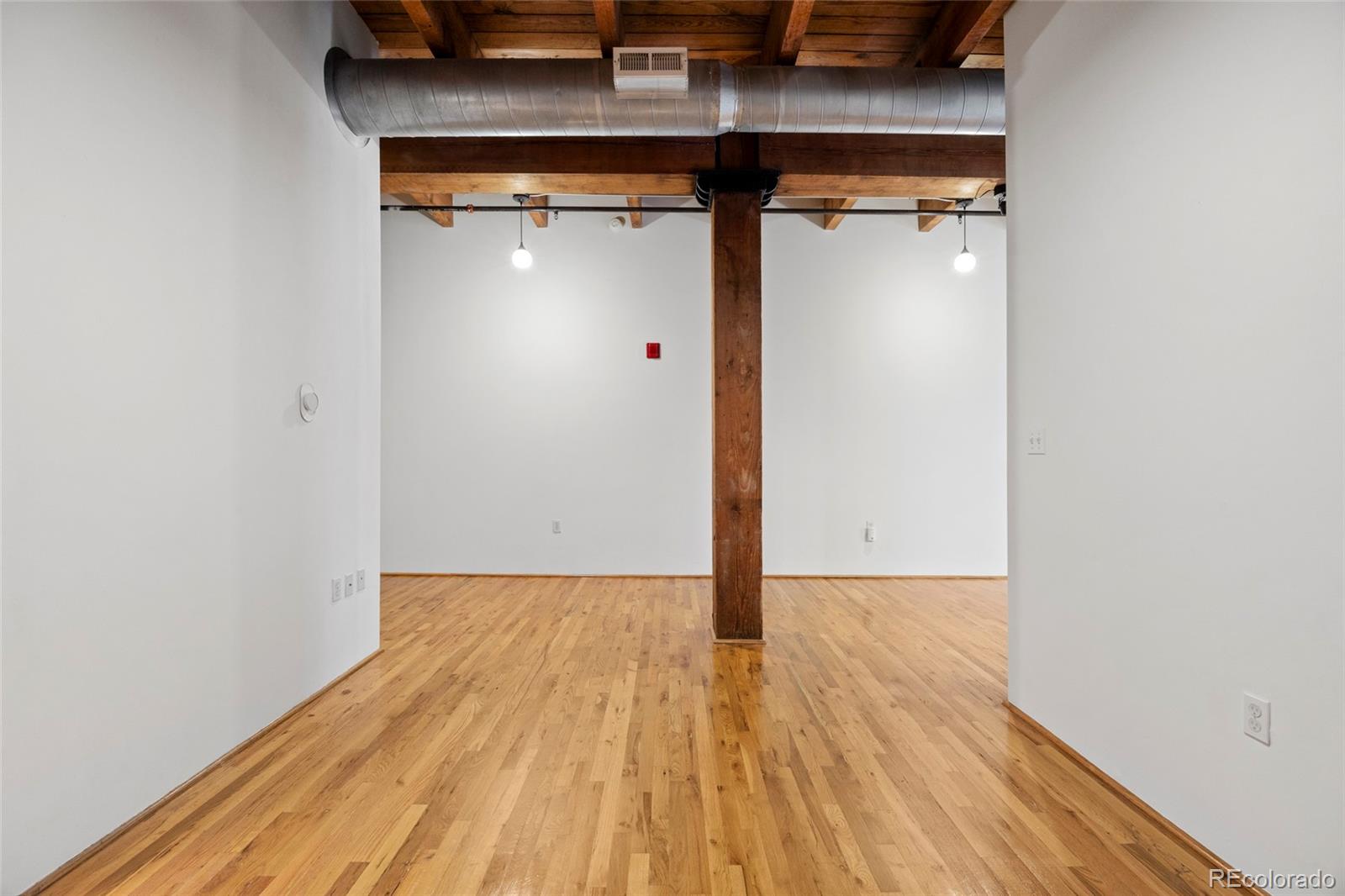 2960 Inca Street, Unit 208 Denver, CO 80202 - Photo 23 of 43 a view of a hallway with wooden floor