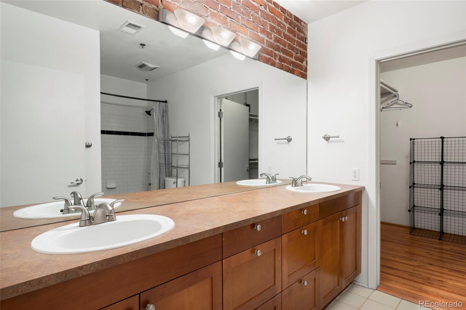 2960 Inca Street, Unit 208 Denver, CO 80202 - Photo 24 of 43 a bathroom with a sink double vanity and a mirror