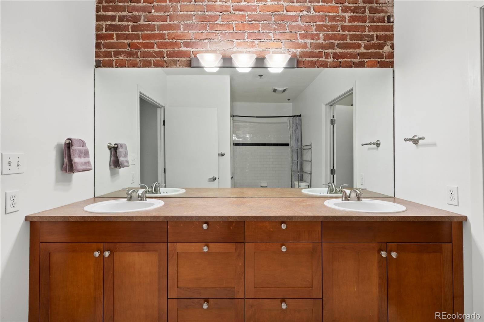 2960 Inca Street, Unit 208 Denver, CO 80202 - Photo 25 of 43 a bathroom with a sink and a mirror