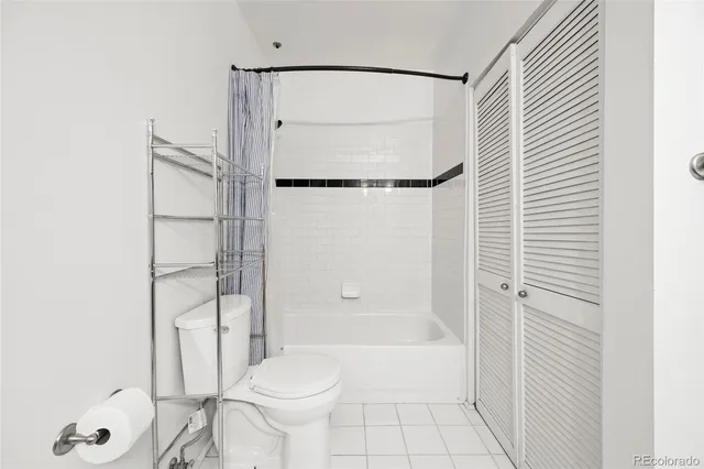 a bathroom with a shower a toilet and a shower