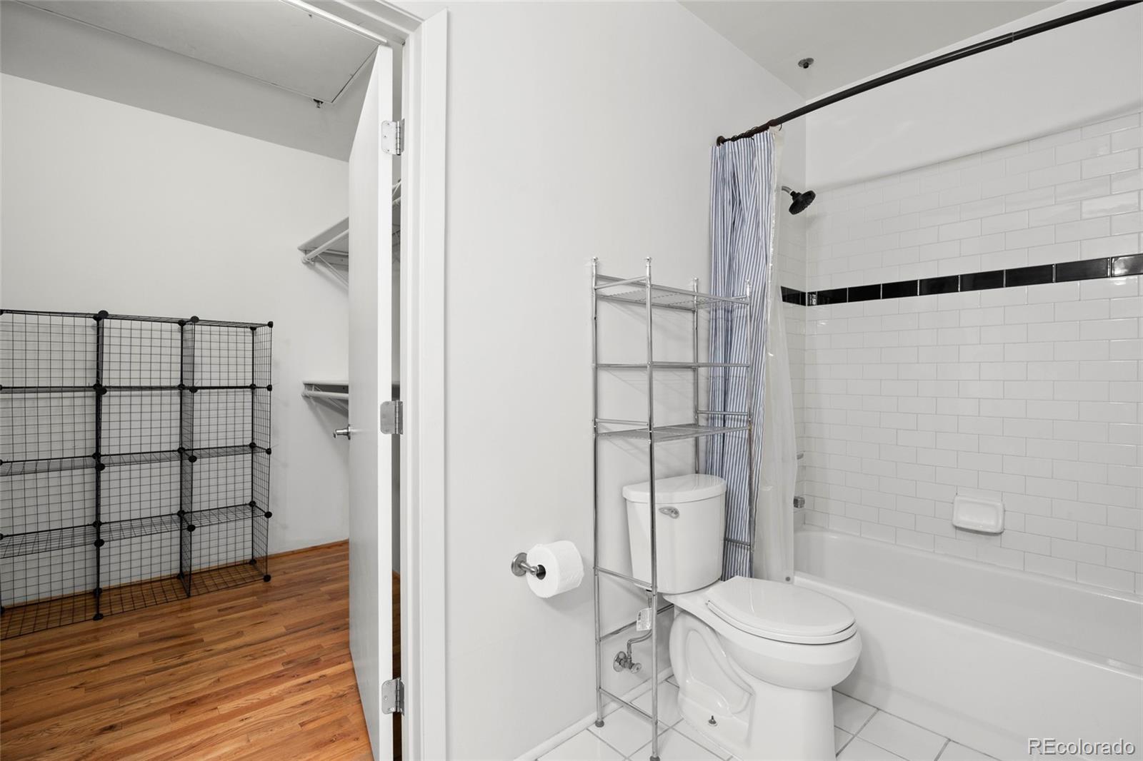 2960 Inca Street, Unit 208 Denver, CO 80202 - Photo 27 of 43 a bathroom with a shower a toilet and a shower