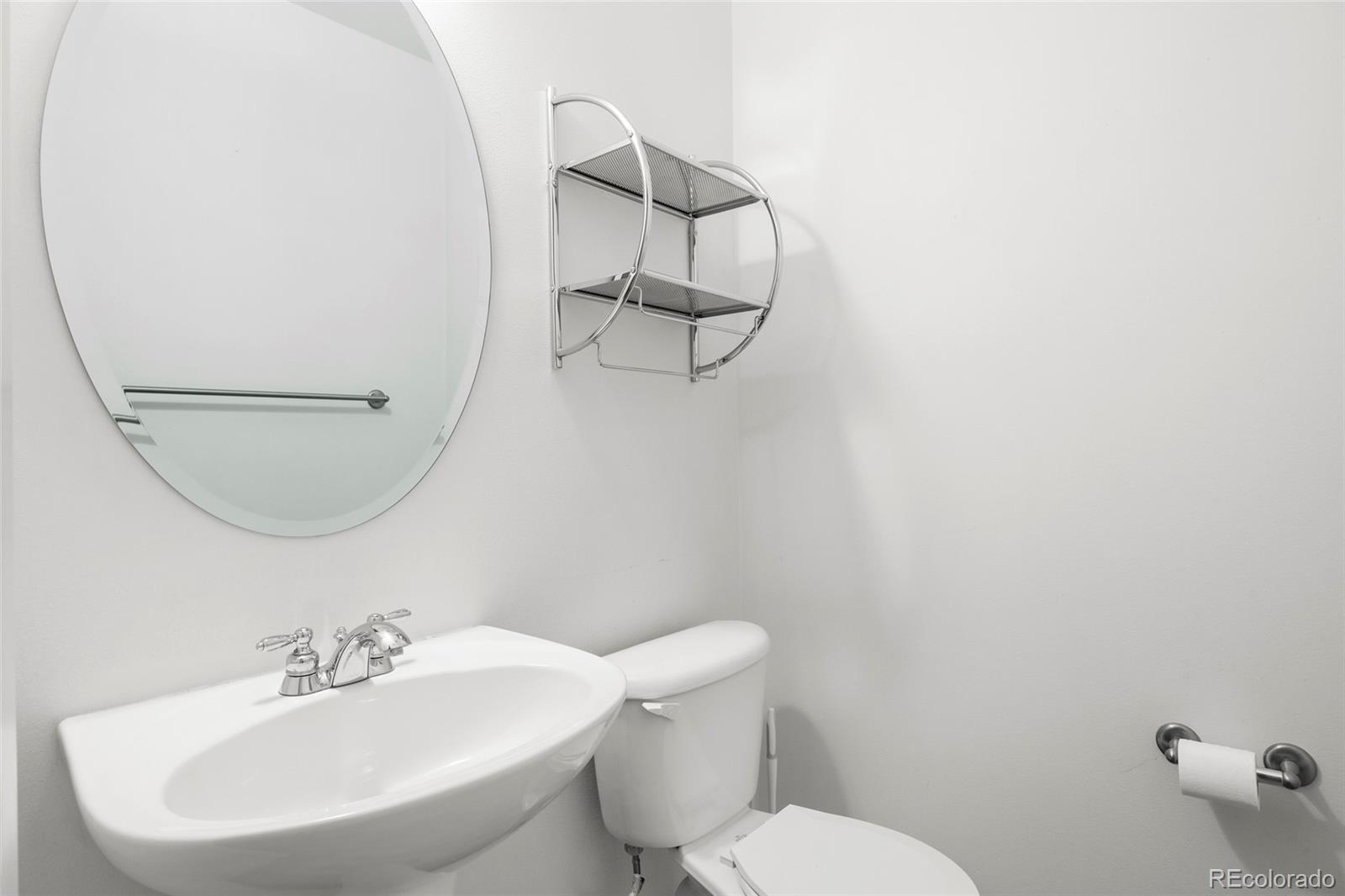 2960 Inca Street, Unit 208 Denver, CO 80202 - Photo 29 of 43 a bathroom with a sink mirror and toilet