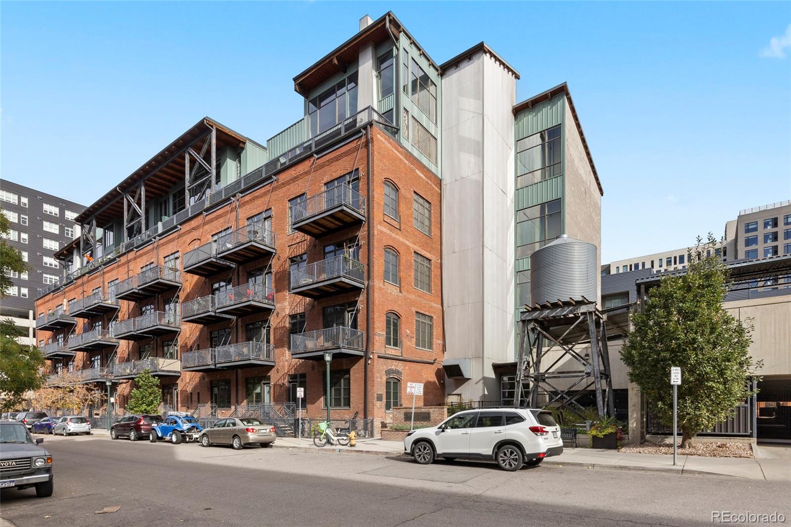 2960 Inca Street, Unit 208 Denver, CO 80202 - Photo 33 of 43 a city street with tall buildings and cars parked in front of it
