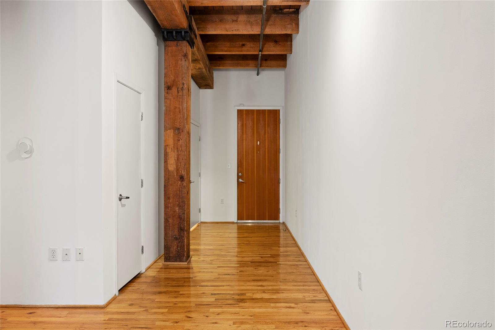 2960 Inca Street, Unit 208 Denver, CO 80202 - Photo 4 of 43 a view of a hallway with wooden floor and entryway