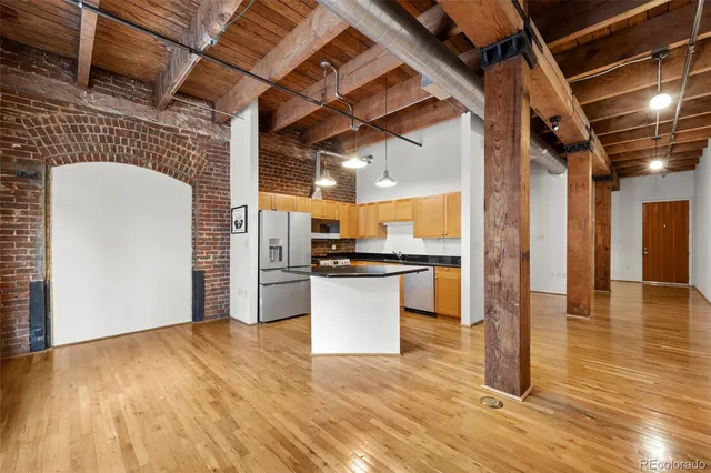 a view of a kitchen with a refrigerator and a stove