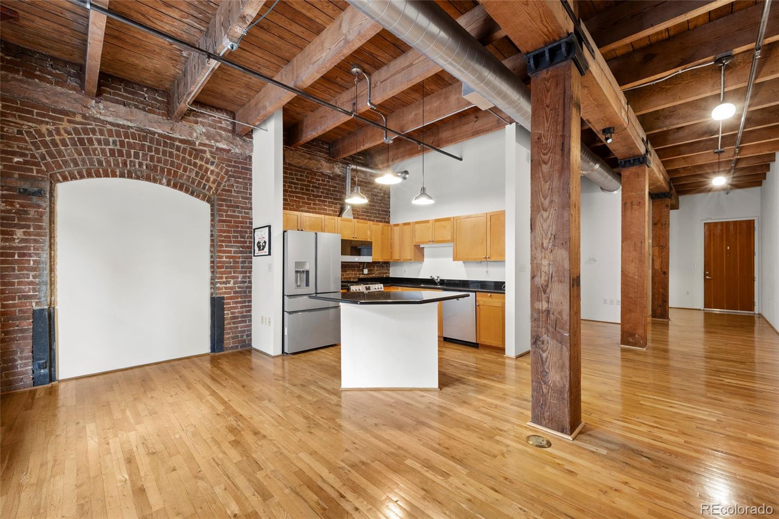 2960 Inca Street, Unit 208 Denver, CO 80202 - Photo 5 of 43 a view of a kitchen with a refrigerator and a stove