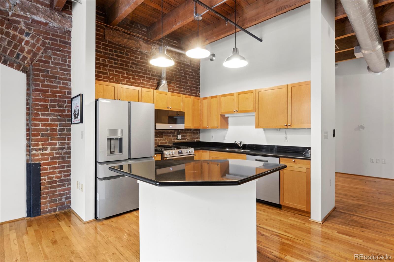2960 Inca Street, Unit 208 Denver, CO 80202 - Photo 7 of 43 a kitchen with stainless steel appliances granite countertop a refrigerator a sink and a stove