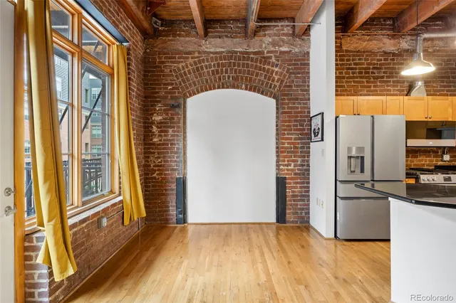 a view of a refrigerator in kitchen and wooden floor
