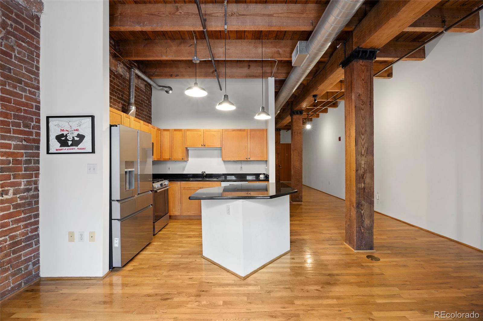 2960 Inca Street, Unit 208 Denver, CO 80202 - Photo 9 of 43 a kitchen with stainless steel appliances granite countertop a refrigerator a sink and a stove