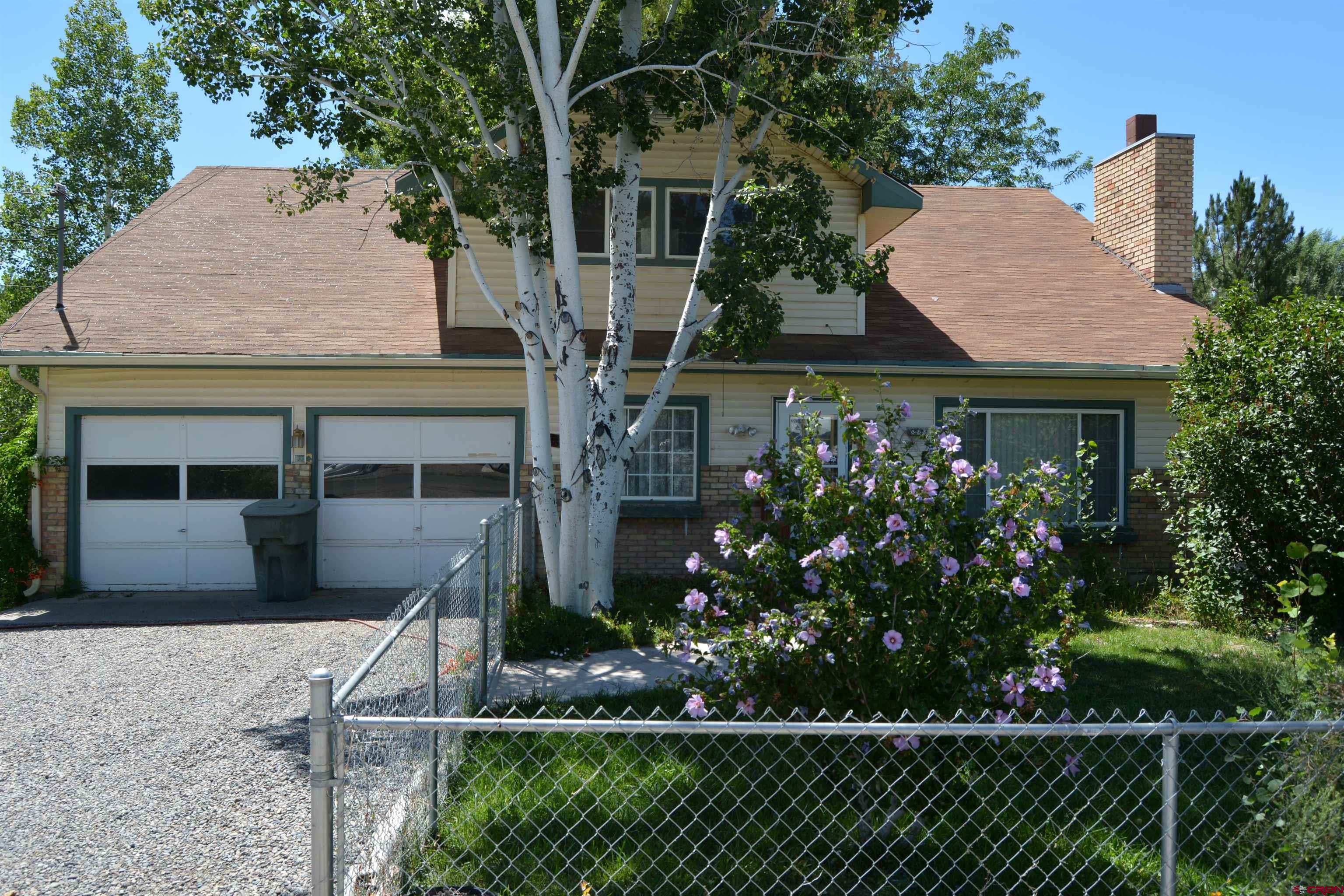 760 1575th Road Delta, CO 81416 - Photo 1 of 27 a front view of a house with a garden