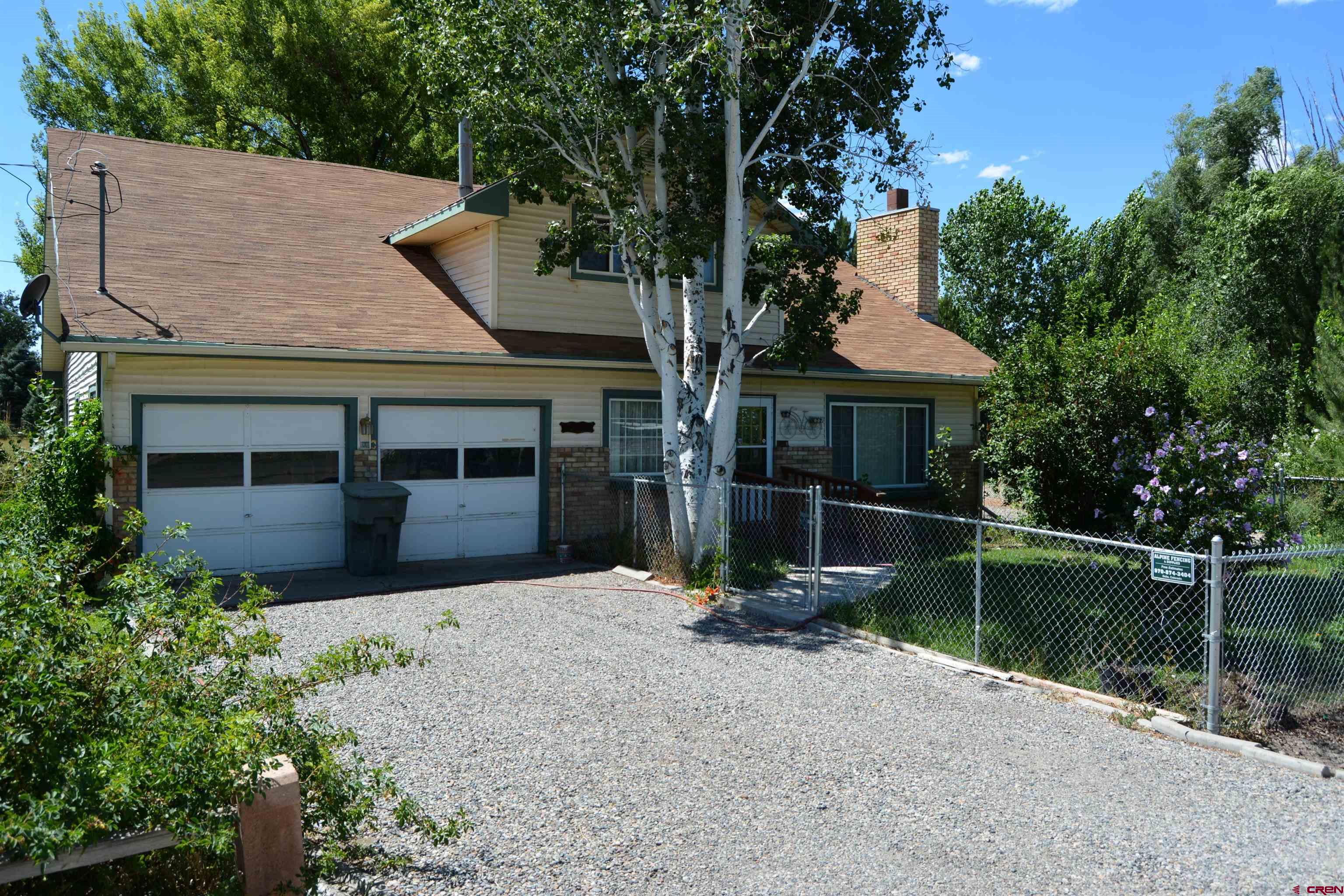 760 1575th Road Delta, CO 81416 - Photo 2 of 27 a front view of a house with a garden
