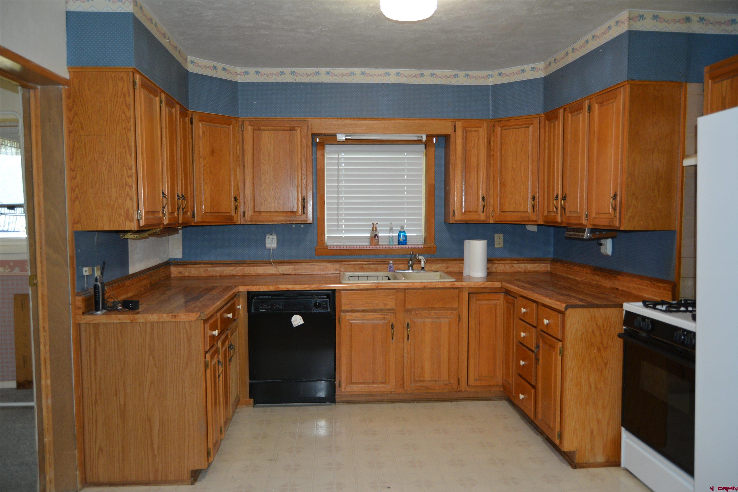 760 1575th Road Delta, CO 81416 - Photo 6 of 27 a kitchen with stainless steel appliances granite countertop a sink a stove and a refrigerator