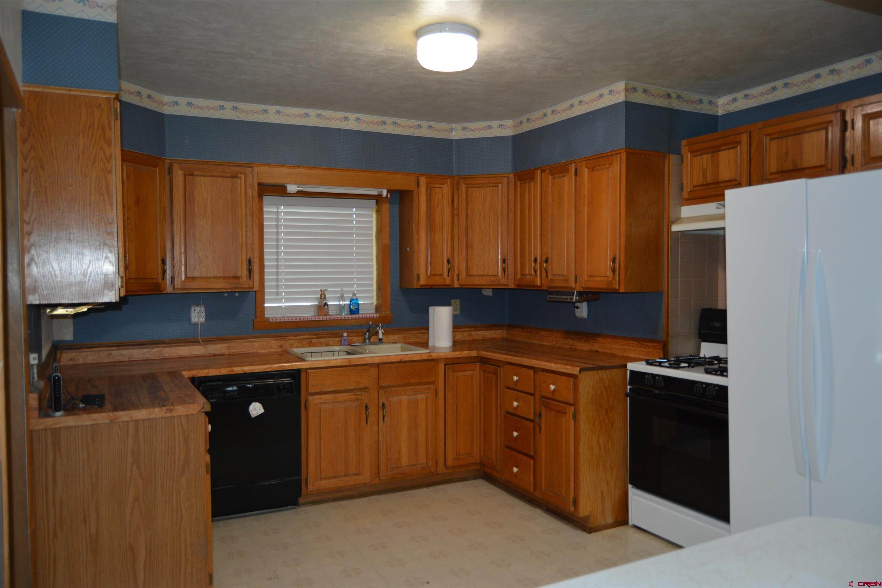 760 1575th Road Delta, CO 81416 - Photo 7 of 27 a kitchen with a sink and cabinets