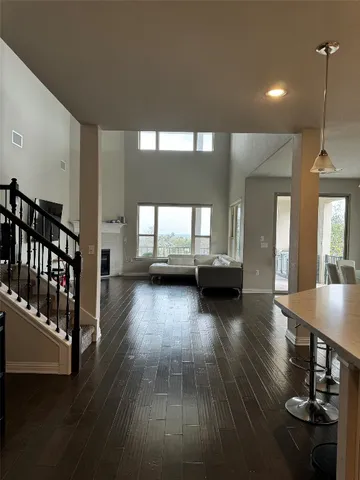 a view of a living room and dining room with wooden floor