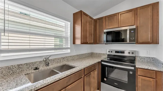 a kitchen with a sink stove and microwave