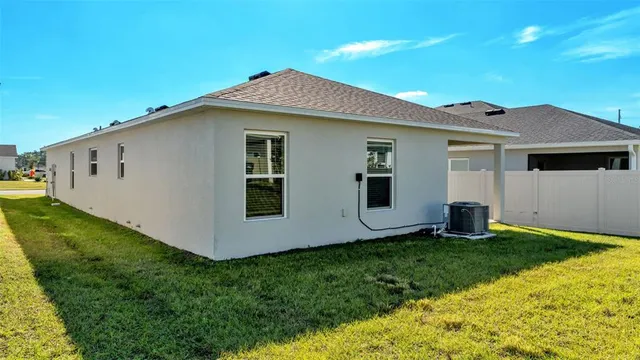 an aerial view of residential houses with outdoor space and street view