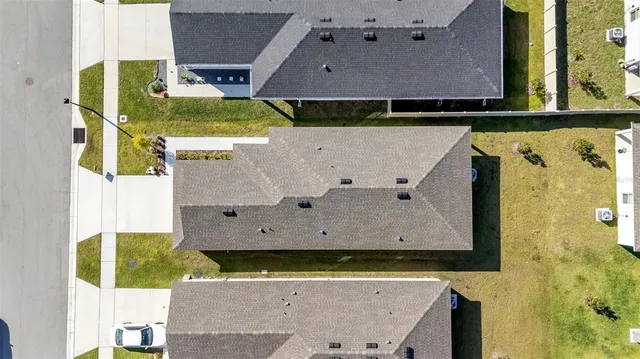 an aerial view of a residential houses with outdoor space
