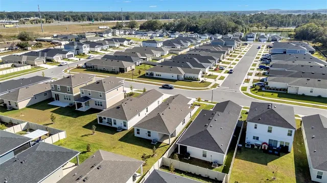 an aerial view of residential houses with outdoor space