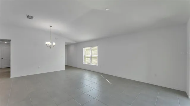 an empty room with a empty space and windows